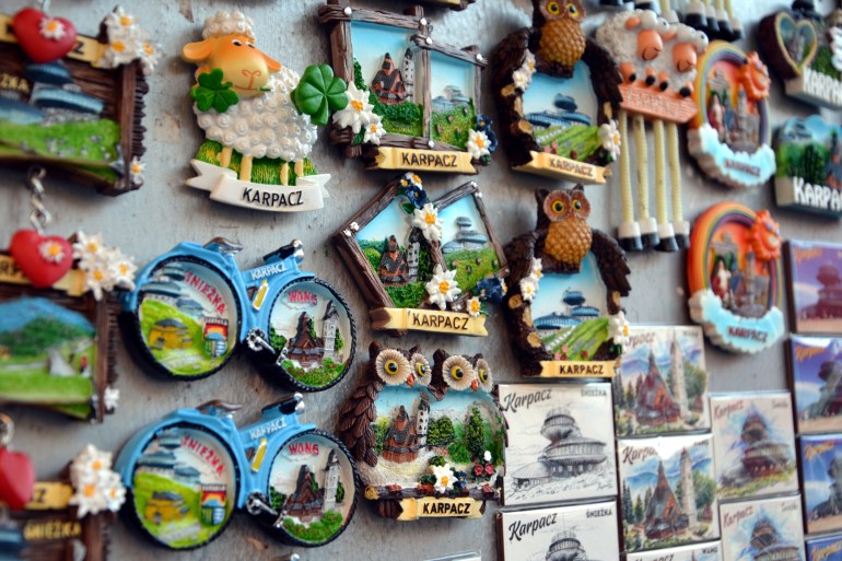 Karpacz, Poland - August 11 2023: Souvenirs, shaped fridge magnets with symbols of Karpacz town and Giant Mountains. Colorful fridge magnets for sale. Selective focus