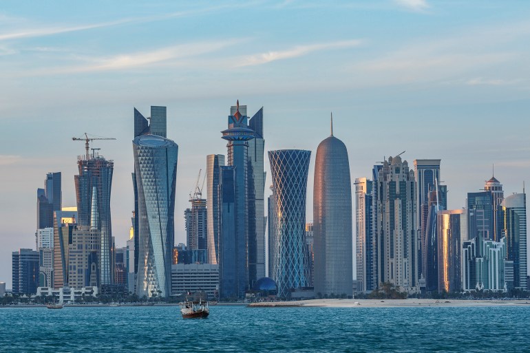 "Boat floating near Doha skyline, Doha, Qatar"