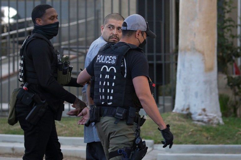 Los Angeles, CA - September 08: Immigration and Customs Enforcement agents apprehend an an illegal immigrant with criminal record, in an early morning raid at home on Thursday, Sept. 8, 2022 in Los Angeles, CA. (Irfan Khan / Los Angeles Times via Getty Images)