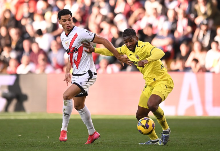 MADRID, SPAIN - FEBRUARY 22: Willy Kambwala of Villarreal CF controls the ball while being put under pressure from Etienne Eto'o Pineda of Rayo Vallecano during the LaLiga match between Rayo Vallecano and Villarreal CF at Estadio de Vallecas on February 22, 2025 in Madrid, Spain. (Photo by Denis Doyle/Getty Images)