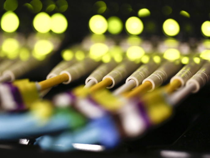 Green LED lights and rows of fibre optic cables are seen feeding into a computer server inside a comms room at an office in London, U.K., on Tuesday, Dec. 23, 2014. Vodafone Group Plc will ask telecommunications regulator Ofcom to guarantee that U.K. wireless carriers, which rely on BT's fiber network to transmit voice and data traffic across the country, are treated fairly when BT sets prices and connects their broadcasting towers.