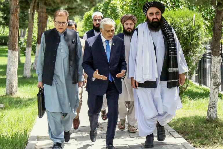 This handout photograph taken on April 19, 2025, and released by Afghanistan's Ministry of Foreign Affairs shows the country's Foreign Minister Amir Khan Muttaqi (R) walking with his Pakistan counterpart Ishaq Dar (C) upon his arrival for a bilateral meeting in Kabul. Afghanistan's foreign minister expressed "deep concern and disappointment" to his Pakistani counterpart on April 19 over the forced deportation of tens of thousands of Afghans since the start of April. (Photo by Afghanistan's Ministry of Foreign Affairs / AFP) / RESTRICTED TO EDITORIAL USE - MANDATORY CREDIT "AFP PHOTO / - / HANDOUT / AFGHANISTAN'S MINISTRY OF FOREIGN AFFAIRS" - NO MARKETING NO ADVERTISING CAMPAIGNS - DISTRIBUTED AS A SERVICE TO CLIENTS