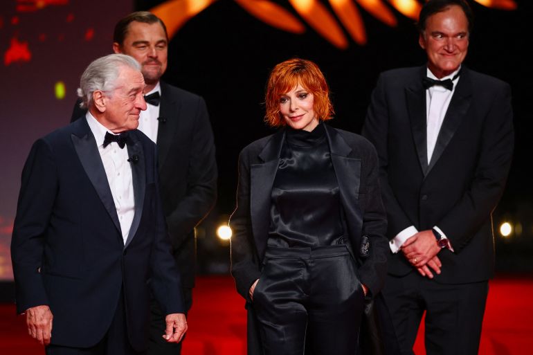Leonardo DiCaprio, Quentin Tarantino, Robert De Niro and Mylene Farmer, pose on stage at the end of the opening ceremony, before the screening the film "Partir un jour" (Leave One Day) Out of competition at the 78th Cannes Film Festival in Cannes, France, May 13, 2025. REUTERS/Sarah Meyssonnier
