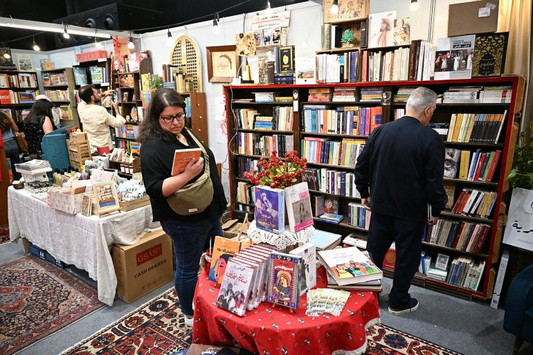 Lebanon's Prime Minister Nawaf Salam (L) visits the 66th Beirut Arab International Bookfair in the Lebanese capital on May 15, 2025. (Photo by Joseph EID / AFP)