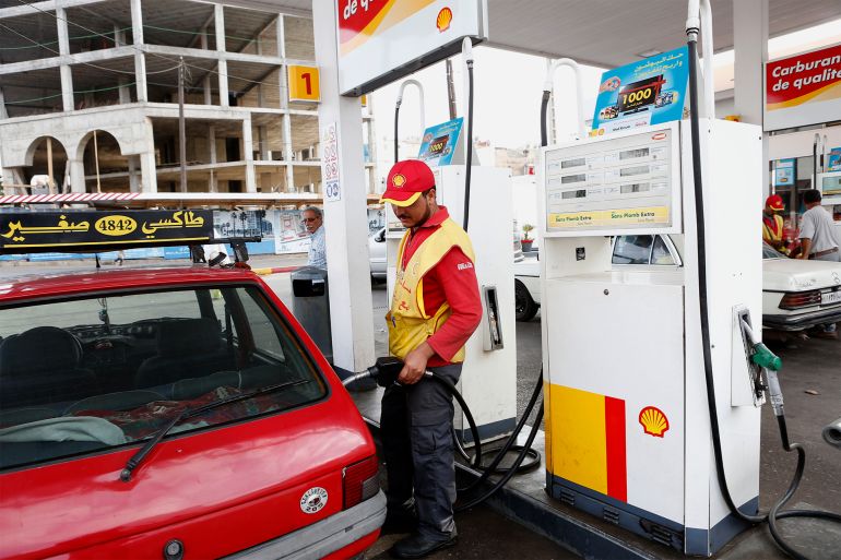 A Moroccan gas station attendant pumps gasoline into customer’s car at a Shell station in Casablanca Thursday, Sept. 5, 2013. Morocco has announced a new system of pricing gasoline and diesel by linking it to the price of oil on the world's markets in an effort to cut its bloated subsidies bill. (AP Photo/Abdeljalil Bounhar)