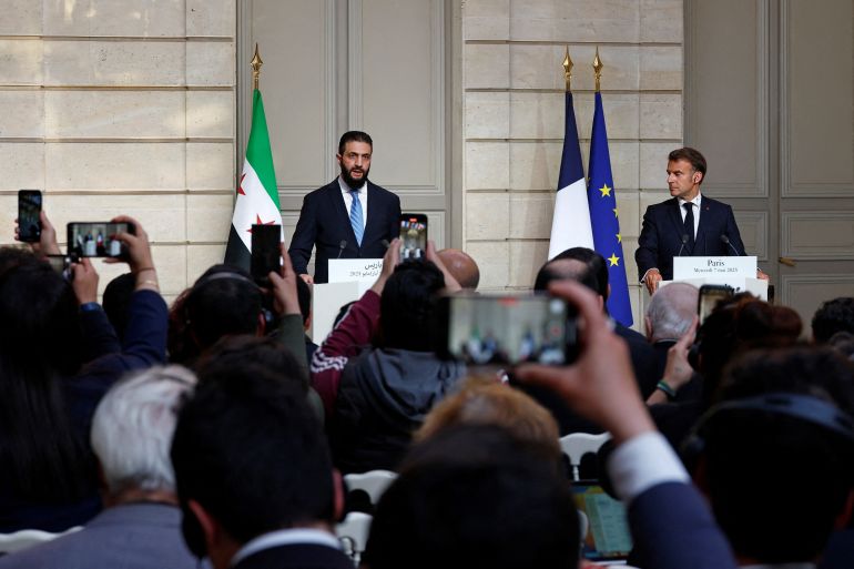 French President Emmanuel Macron (R) and Syrian President Ahmed al-Sharaa attend a joint press conference after a meeting at the Elysee Palace in Paris, on May 7, 2025. Syrian interim President Ahmed al-Sharaa arrived in Paris on May 7, state media reported, on his first visit to Europe since overthrowing longtime ruler Bashar al-Assad in December. (Photo by Stephanie Lecocq / POOL / AFP)