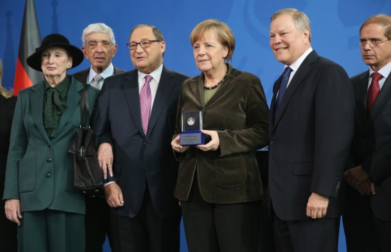 BERLIN, GERMANY - MARCH 19: German Chancellor Angela Merkel poses with delegation members of the Anti-Defamation League, including National Chair Barry Curtiss-Lusher (R of Merkel) and ADL National Director Abraham Foxman (L of Merkel) after they awarded her the Joseph Prize for Human Rights during a ceremony at the Chancellery on March 19, 2014 in Berlin, Germany. The ADL awarded the prize to Merkel in recognition of her outspoken commitment to human rights and her support of Israel. (Photo by Sean Gallup/Getty Images)