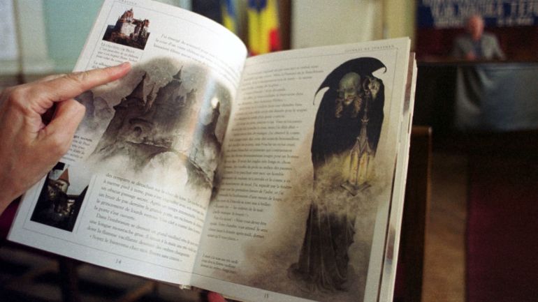 389231 01: One of the participants at the World Dracula Symposium looks through an illustrated French version of Brahm Stoker's Dracula May 9, 2001 during discussions in Sighisoara, Romania. The event, hosted by the Transylvanian Society of Dracula, brought experts in the fields of history, literature and pathology from around the world to discuss Stoker's character, but more importantly Vlad Dracula 'The Impaler' Tepes, a Romanian military hero who's birthplace is Sighisoara. (Photo by David Greedy/Getty Images)