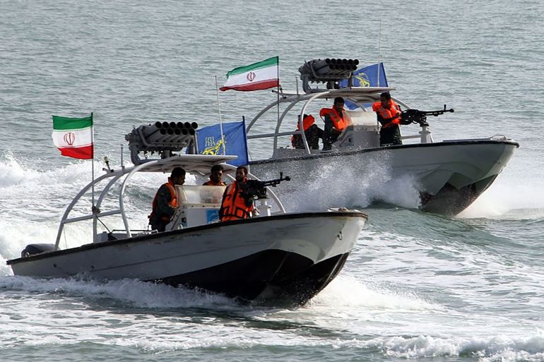 Iranian Revolutionary Guards drive speedboats during a ceremony to commemorate the 24th anniversary of the downing of Iran Air flight 655 by the US navy, at the port of Bandar Abbas on July 2, 2012. The plane was shot down by mistake over the Gulf by the US navy's guided missile cruiser, USS Vincennes, during confrontation with Iranian speedboats on July 3, 1988, killing 290 civilian passengers and crew members. AFP PHOTO/ATTA KENARE (Photo by ATTA KENARE / AFP)
