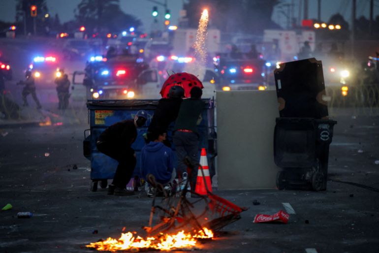 A protester fires a firework during a standoff between police and protesters following multiple detentions by Immigration and Customs Enforcement (ICE), in the Los Angeles County city of Paramount, California, U.S., June 7, 2025. REUTERS/Daniel Cole TPX IMAGES OF THE DAY