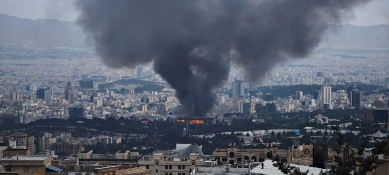 TEHRAN, IRAN - JUNE 16: Smoke rises after a reported Israeli strike on a building used by Islamic Republic of Iran News Network, part of Iran's state TV broadcaster, on June 16, 2025 in Tehran, Iran. Over recent days, Iran has been hit by a series of Israeli airstrikes targeting military and nuclear sites, as well as top military officials, prompting Iran to launch a counterattack. (Photo by Stringer/Getty Images)
