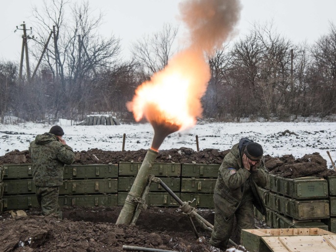 Russian-backed separatists cover their ears as they fire a mortar towards Ukrainian troops outside the village of Sanzharivka, northeast of Debaltseve, eastern Ukraine, Wednesday, Feb. 11, 2015. The leaders of France, Germany, Russia and Ukraine flew to the Belarus capital for crucial peace talks Wednesday as fighting still raged in eastern Ukraine. (AP Photo/Maximilian Clarke)