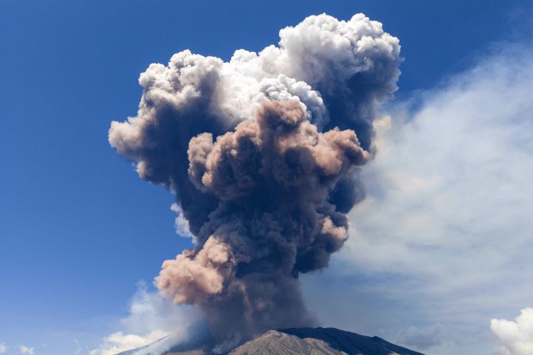 Smoke billows from Mount Etna volcano, Italy, Monday, June 2, 2025. (AP Photo/Giuseppe Distefano)