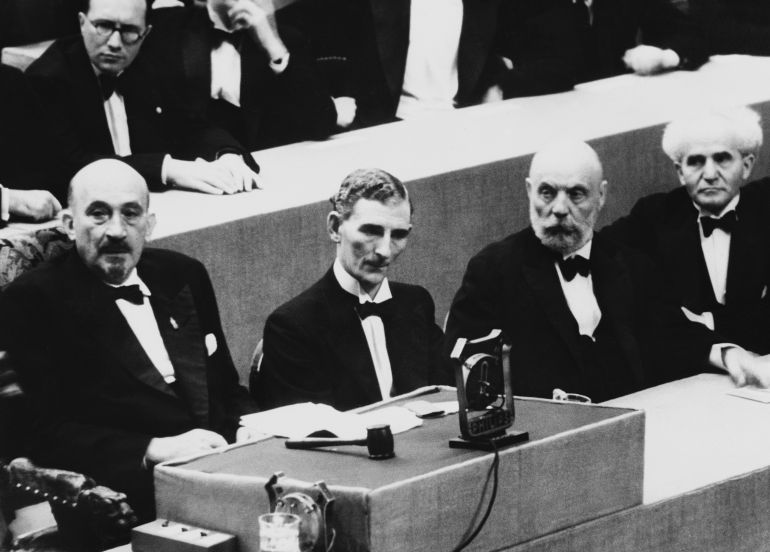 Dr. Chaim Weizmann, presiding over the 21st Zionist Congress in Geneva, made an attack on Great Britain’s White paper proposals for the solution of the Palestine problem in his opening speech. From left to right are Dr. Weizmann, Tom Williams, Mr. Ussischkin, and Ben Gurion at the Zionist congress at Geneva on August 16, 1939. Behind Dr. Weizmann is the Reverend. Perlsweig, leader of English Zionism. (AP Photo)