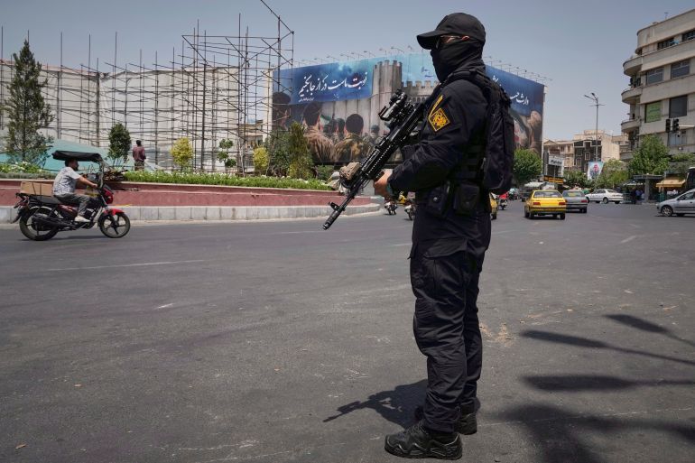 A member of Iran's Revolutionary Guard stands guard at Enqelab-e-Eslami (Islamic Revolution) square in downtown Tehran, Iran, Tuesday, June 24, 2025. (AP Photo/Vahid Salemi)