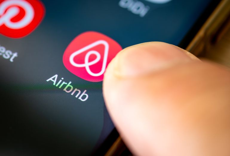 London. UK- 07.28.2024. The American online marketplace app Airbnb for short and long term home stays, on the screen of a cell phone.