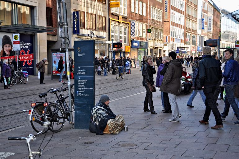 Bremen, Germany - March 5, 2011: The city on the street begging unknown man.