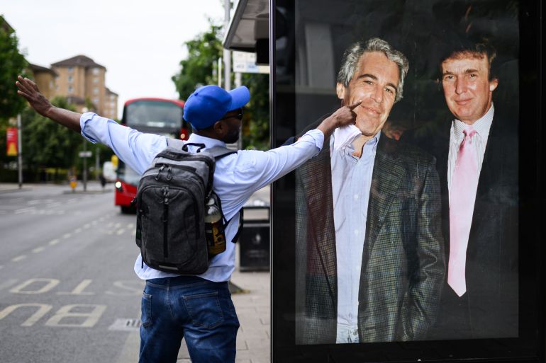 LONDON, ENGLAND - JULY 17: A man gestures to a photograph of US President Donald Trump and convicted child sex offender Jeffrey Epstein after it is unofficially installed in a bus shelter on July 17, 2025 in London, England. The satirical artist behind the stunt has previously targeted Elon Musk and Tesla. The US president is facing criticism from his usually loyal Republican “Make America Great Again” (MAGA) supporters over suggestions that the administration is hiding details of Epstein’s crimes to protect the high profile figures he associated with, which included Trump. Having previously suggested that there was reason to investigate a rumoured list of clients, Trump has now refered to it as a hoax and called those calling for an investigation "weaklings". (Photo by Leon Neal/Getty Images)