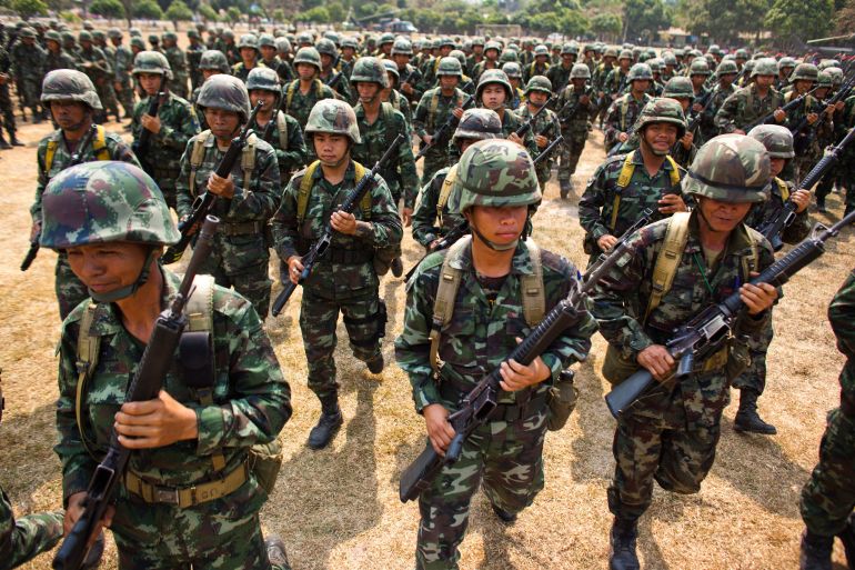SISAKET, THAILAND - FEBRUARY 09: Thai troops march during a visit by top military leaders at a military base on February 9, 2011 in Sisaket, Thailand. Thousands of refugees have fled the area after clashes between Thai and Cambodian troops near the disputed 11th-century Preah Vihear temple. Presently there is no official ceasefire in place as the two countries contest ownership of the 4.6 sq-km area World Heritage site. The 900-year-old temple belongs to Cambodia following a 1962 World Court ruling but this remains disputed by many Thais. (Photo by Athit Perawongmetha/Getty Images)