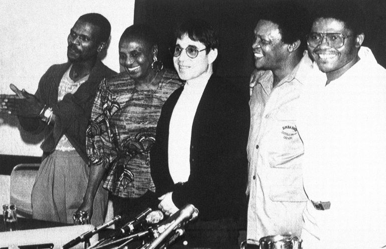 Musician Paul Simon, center, speaks to reporters with African musicians from left, Ray Phiri, Miriam Makeba, Hugh Masekela and Joe Shabalala after arriving in Harare, Zimbabawe on Feb. 13, 1987. Simon and his group will hold two concerts in Zimbabwe based on his best-selling and controversial album, “Graceland.” (AP Photo/Peter Winterbach)
